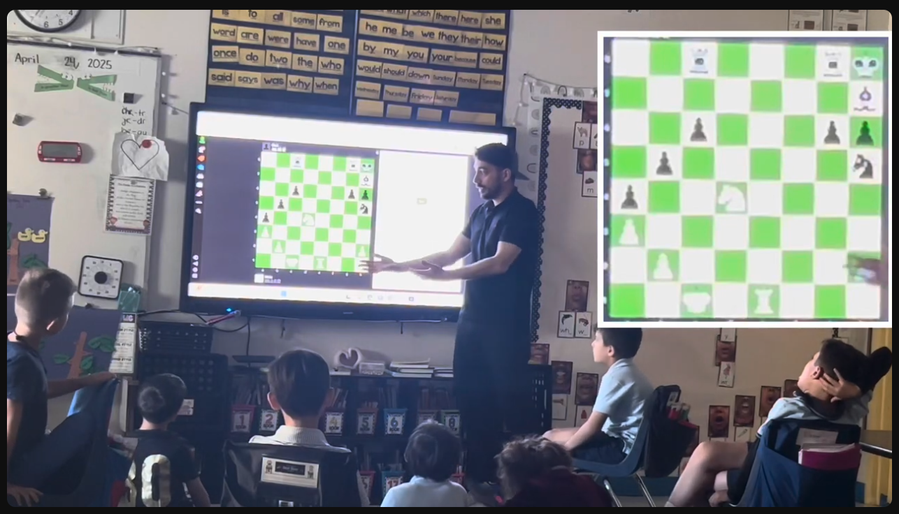 Coach teaching students in a classroom with a digital chessboard on screen