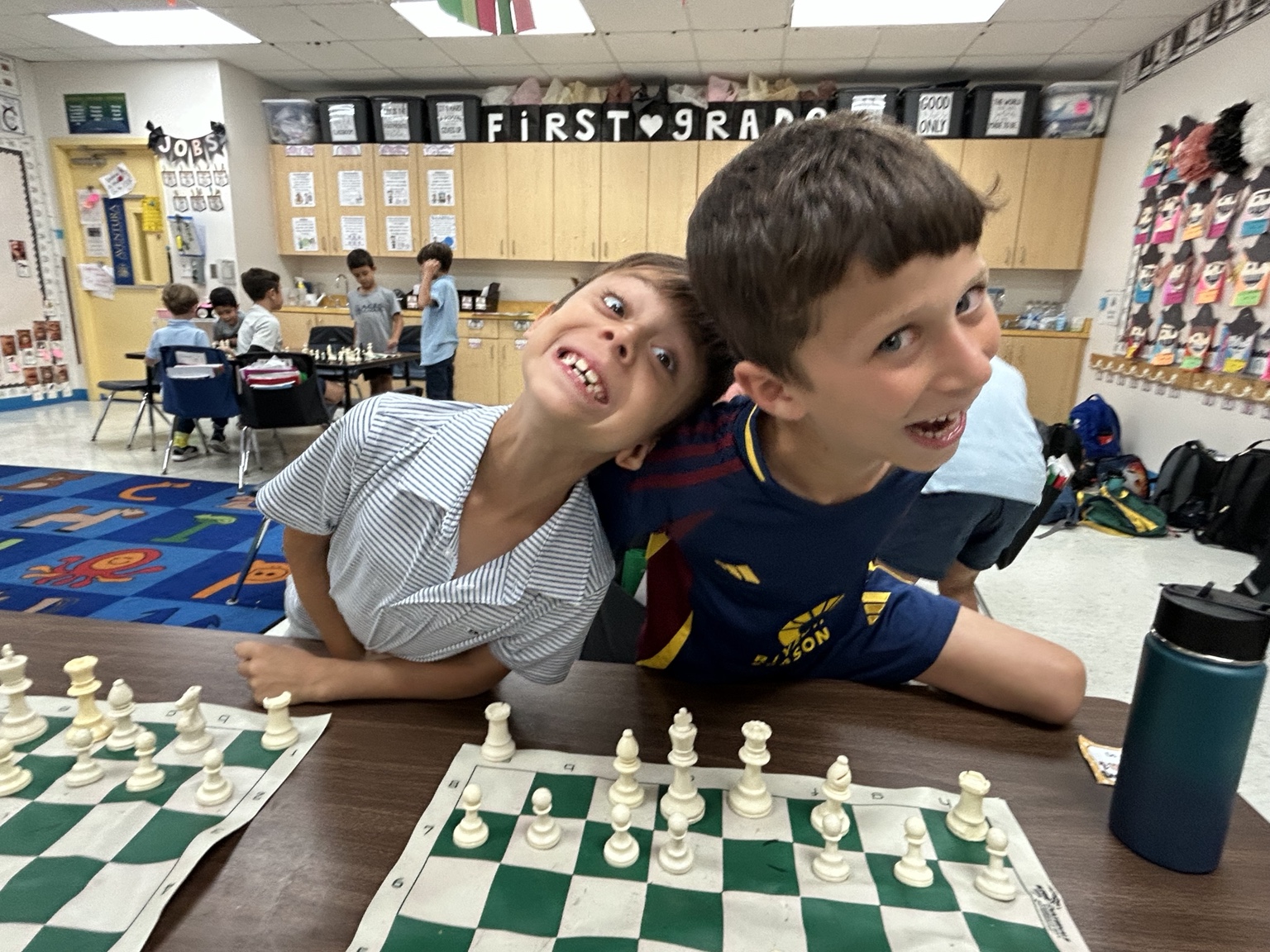 Students playing chess in a classroom
