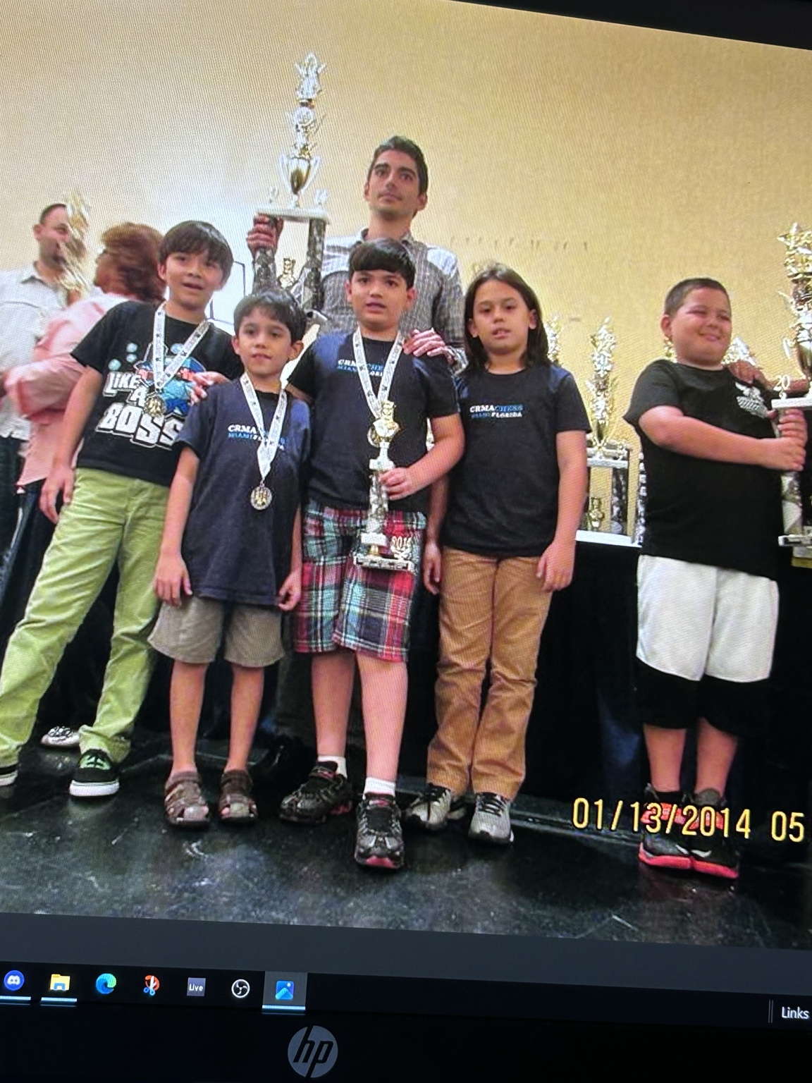 Students celebrating with a chess trophy