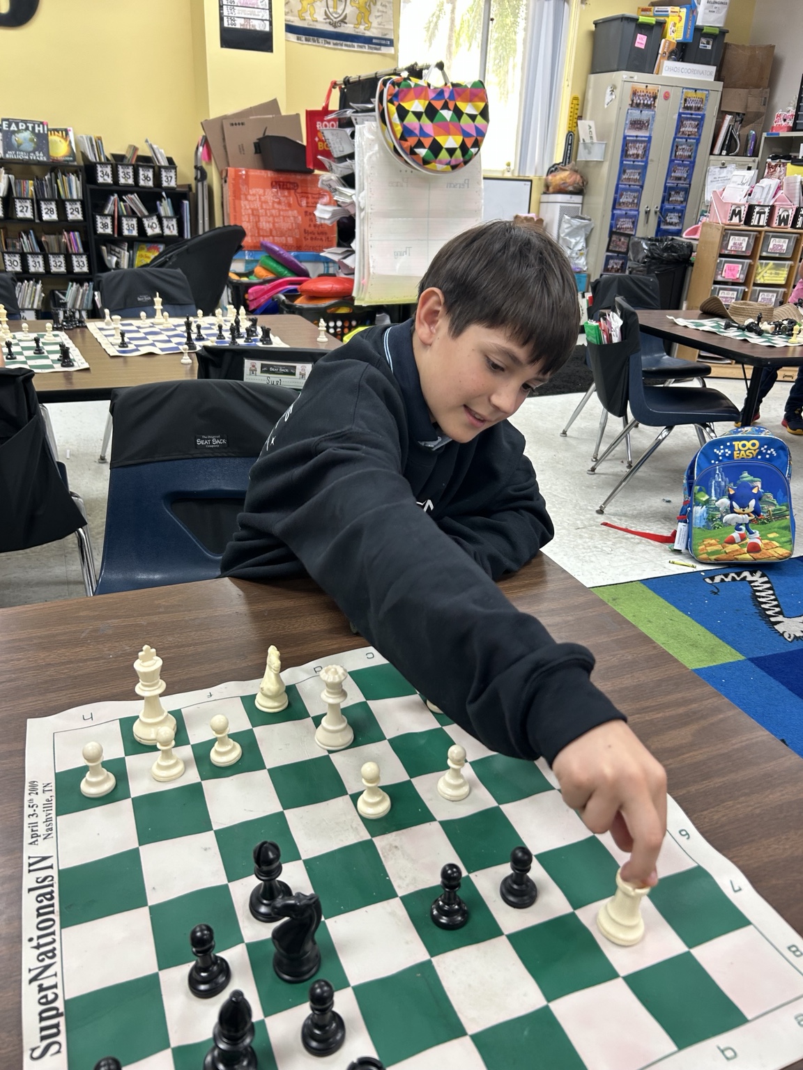 Student making a move during chess class